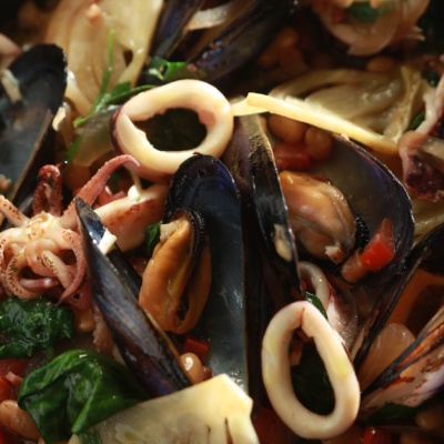 Sauteed squid and steamed mussels with beans, spinach, and pancetta | Yiannis Lucacos