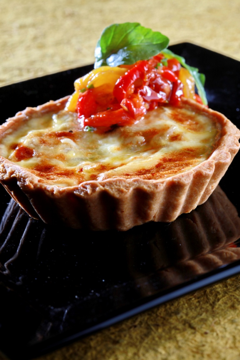 Goat’s cheese tart with caramelized onions and roasted peppers salad